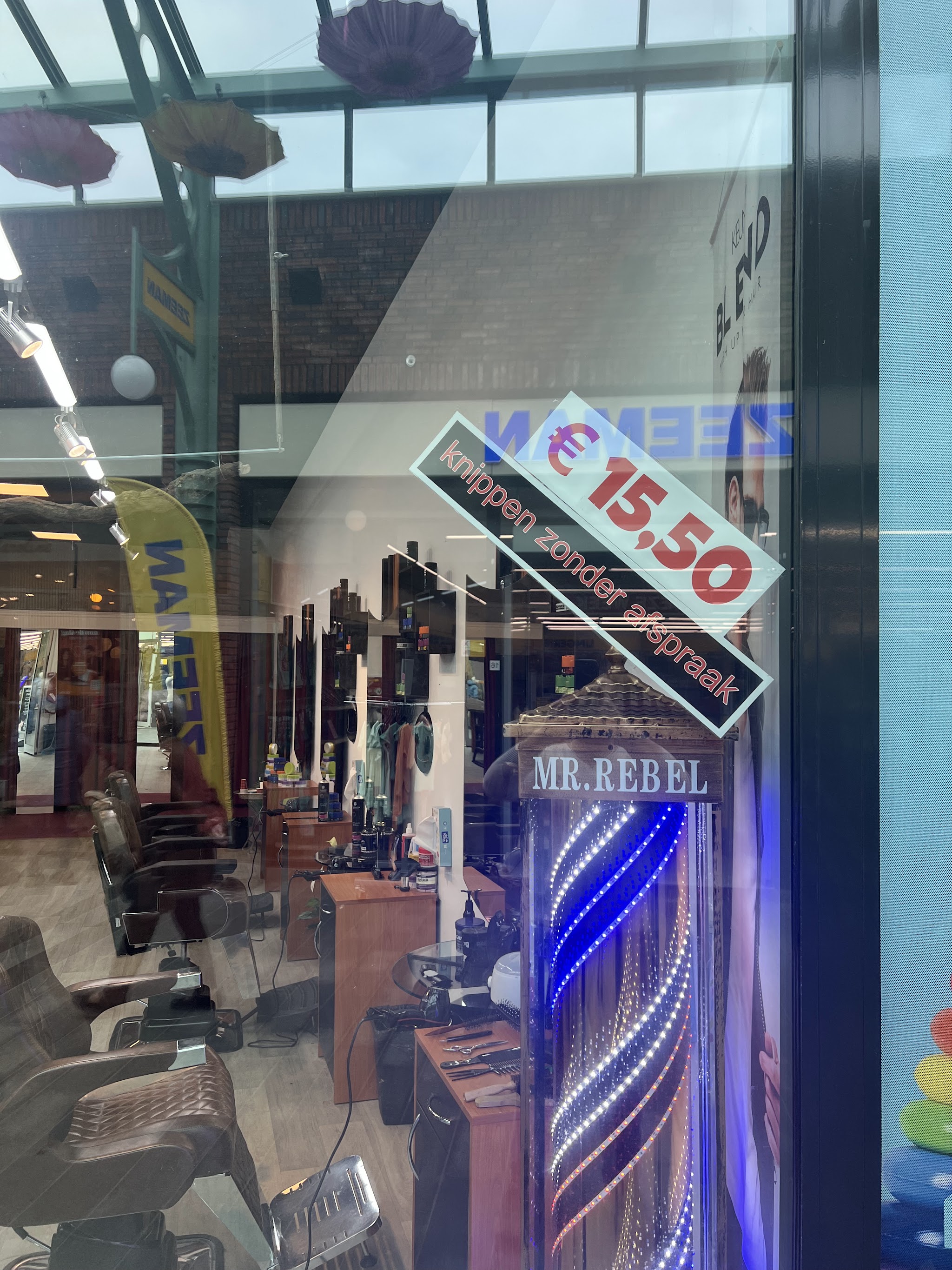De etalageruit van Royal Scissors met de sticker knippen zonder afspraak voor 15,50 euro
